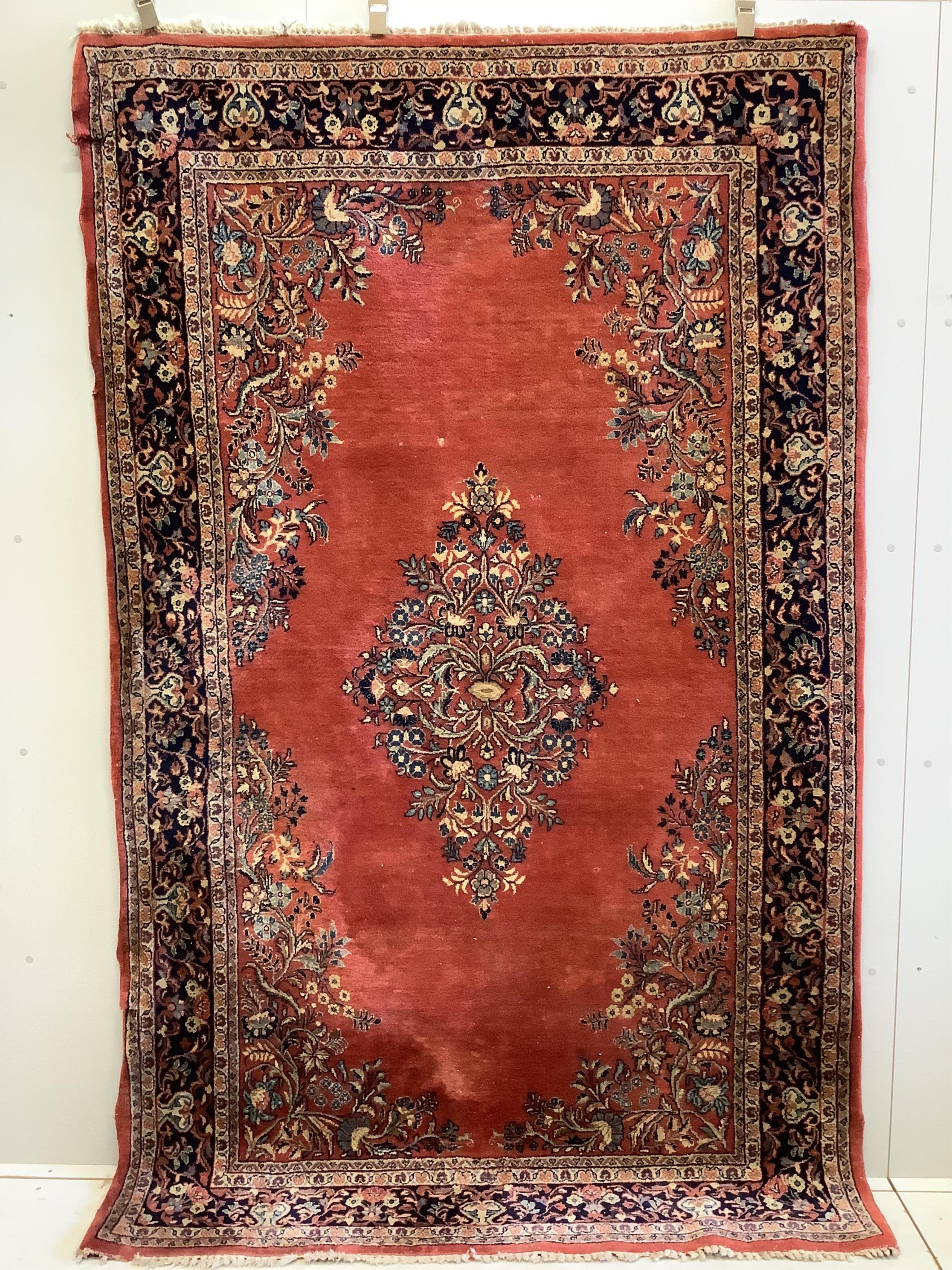 A Sarouk red ground rug, 251 x 154cm